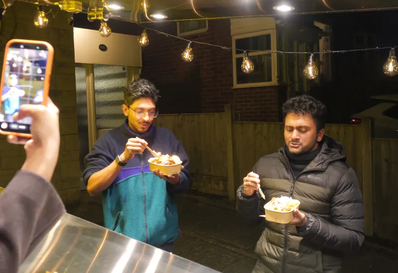 The Lankan Fix team preparing food inside the truck during a busy event shift.