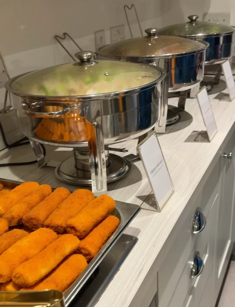 A professional private party catering setup in Sheffield featuring Sri Lankan food stations and buffet displays.