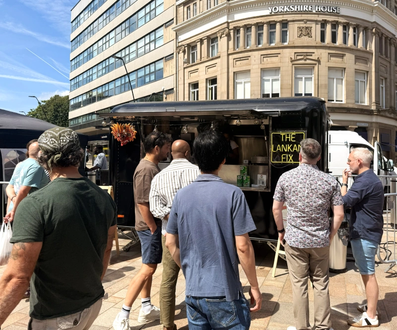 Customers queuing at The Lankan Fix food truck during a Sheffield street food event.